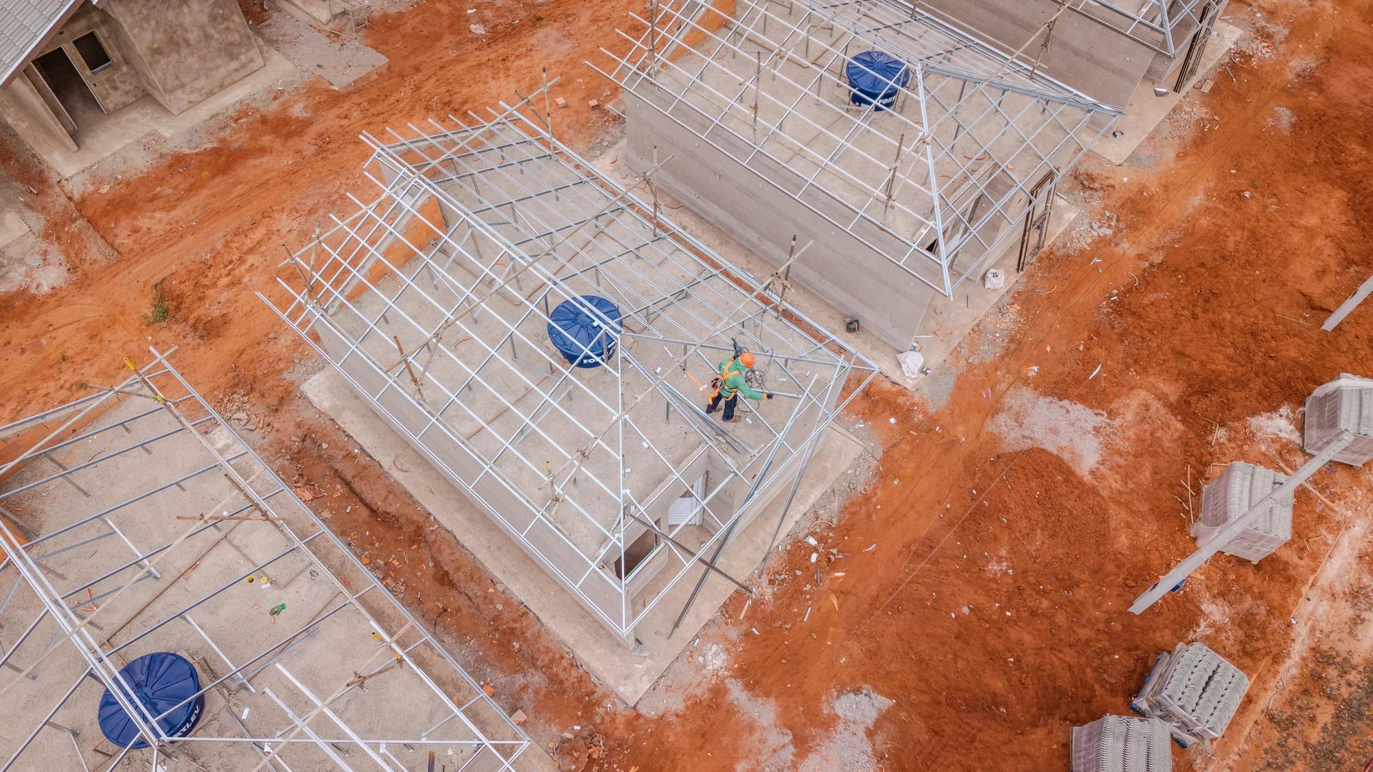 Vista aérea de tesouras metálicas galvanizadas montadas sobre as casas